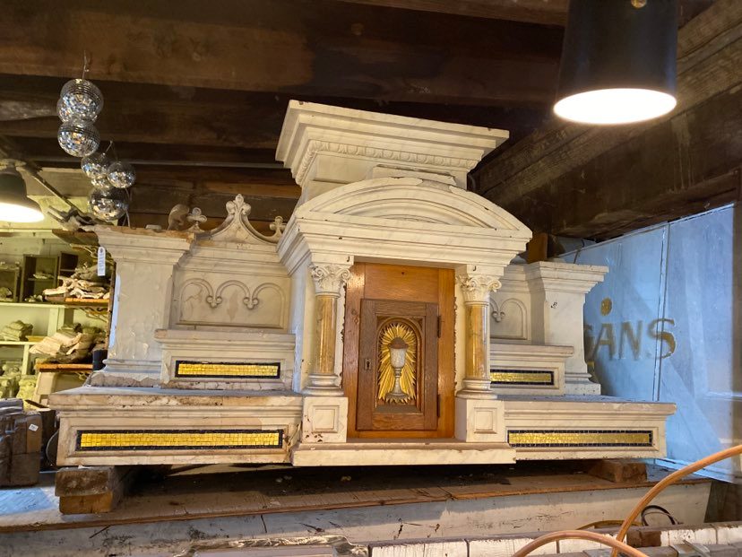 Decorative stone structure with wooden door in a workshop setting