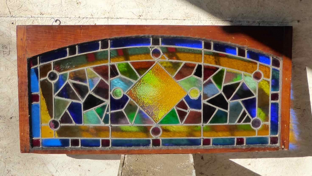 Antique Stained Glass Window with curved top in square frame