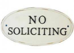 Cast iron oval no soliciting sign.