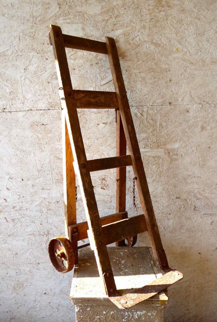 Very old industrial hand cart, all original parts. Made of wood with cast metal wheels.