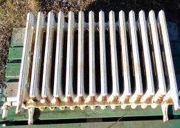 Vintage fourteen fin cast iron radiator – small crack visible, prop only.