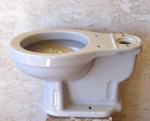 Vintage porcelain toilet. Prop rental only.