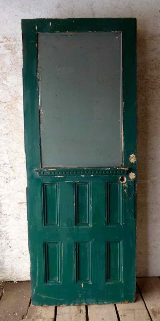 Large antique oversize exterior glazed entry door originally from the historic Walton Hotel in Port Hope Ontario. Originally glazed, been boarded up, needs glass. 
