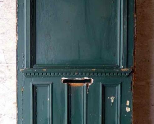 Large antique oversize exterior glazed entry door originally from the historic Walton Hotel in Port Hope Ontario. Originally glazed, been boarded up, needs glass.