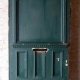 Large antique oversize exterior glazed entry door originally from the historic Walton Hotel in Port Hope Ontario. Originally glazed, been boarded up, needs glass.