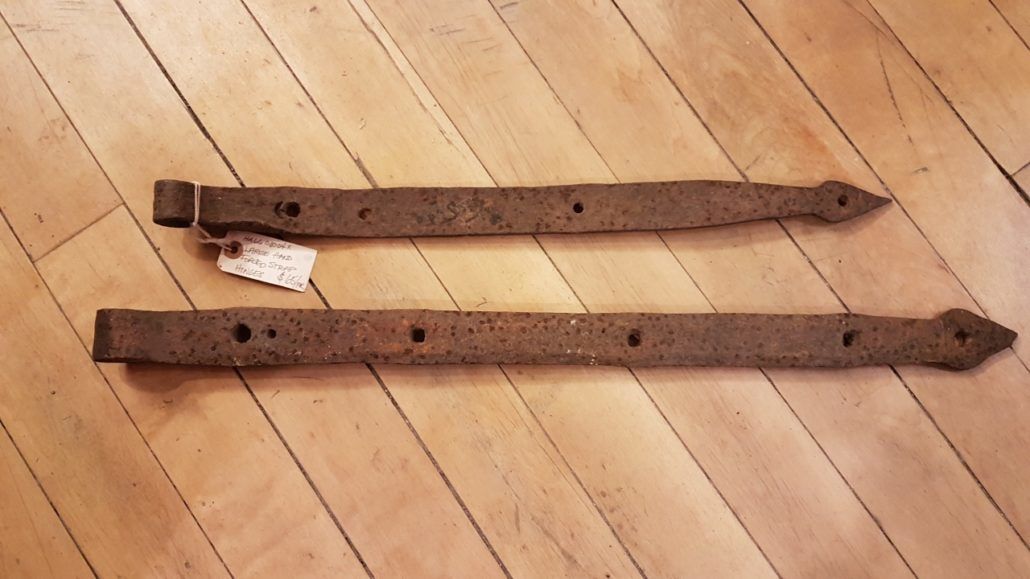 Pair of antique iron strap door hinges in separate sizes