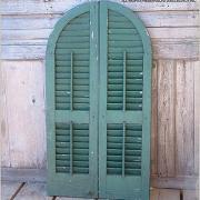 Antique arched louvered shutters