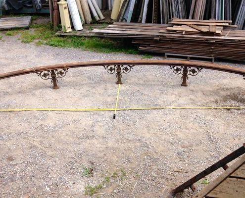 Antique curved rail with ornate cast iron posts