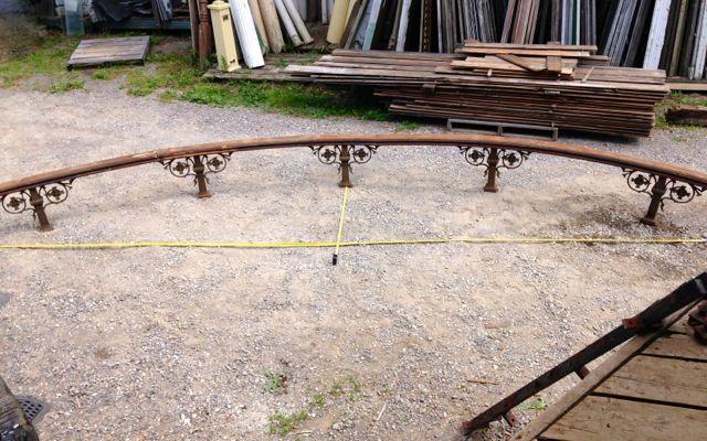 Antique curved rail with ornate cast iron posts