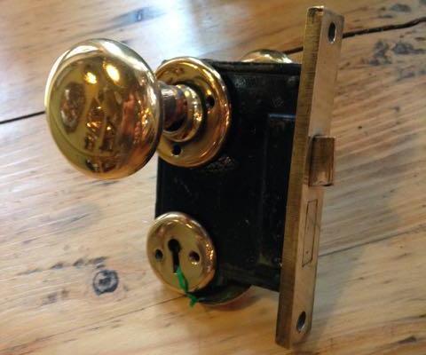 Antique brass passage sets with two brass knobs, two brass rosettes and mortise lock with brass face