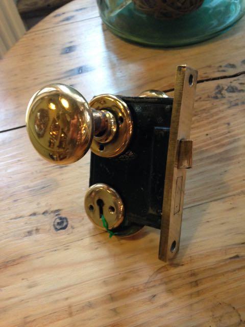 Antique brass passage sets with two brass knobs, two brass rosettes and mortise lock with brass face
