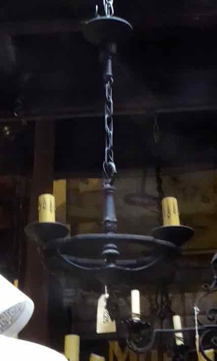 Beautiful antique black cast iron chandelier with two lights. Measures 13 inches in diameter, adjustable drop.