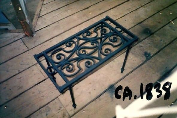 antique window grate made into coffee table